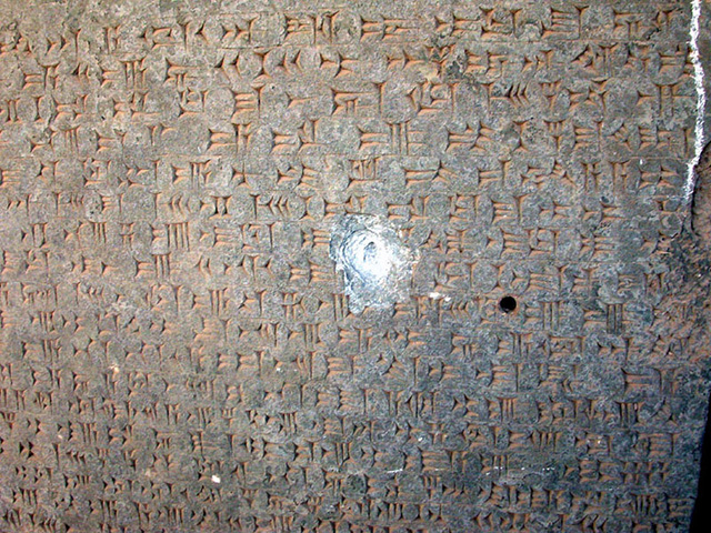bullet hole in an inscription